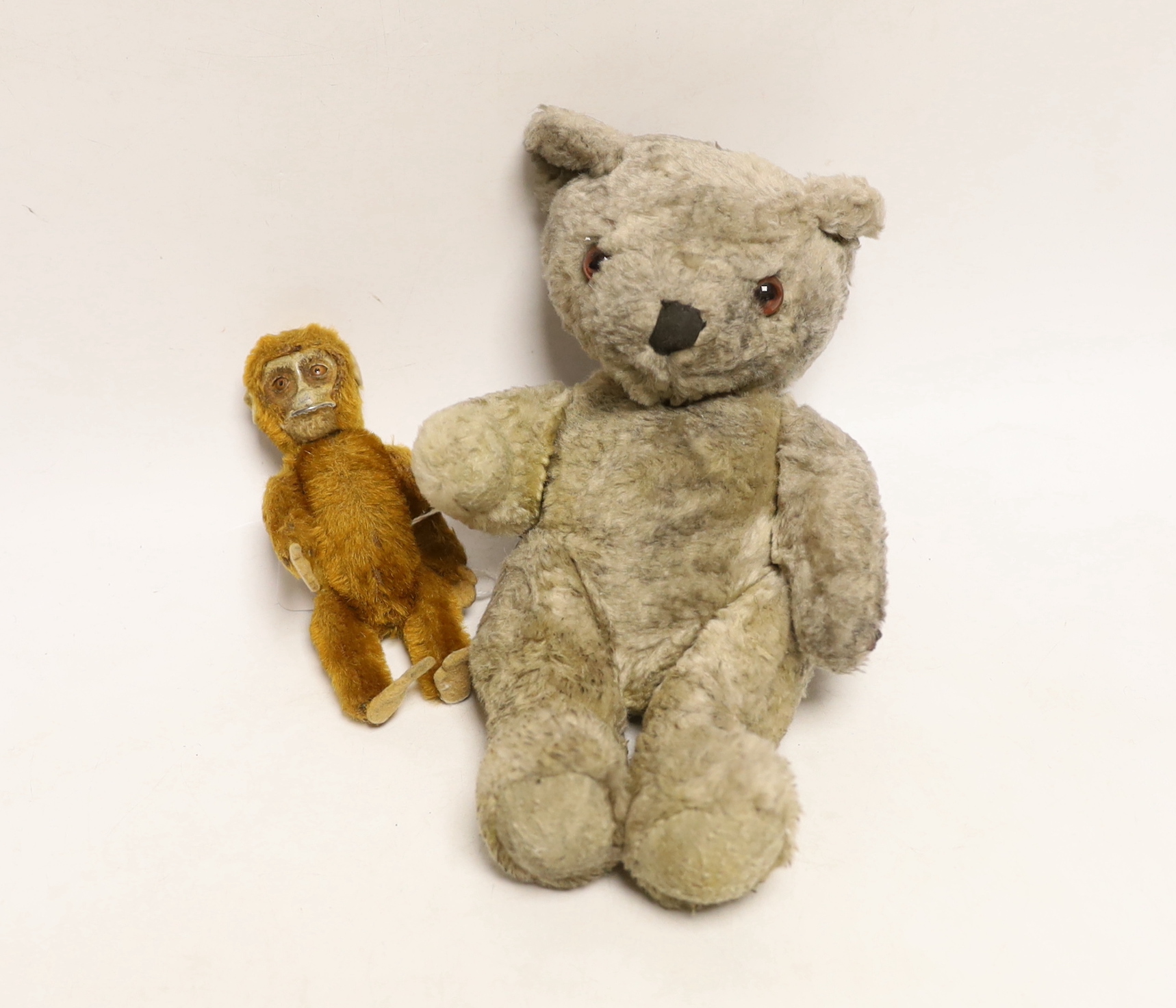 A Schuco vintage perfume bottle in the form of a Monkey and another novelty teddy bear perfume bottle, largest 22cm in length